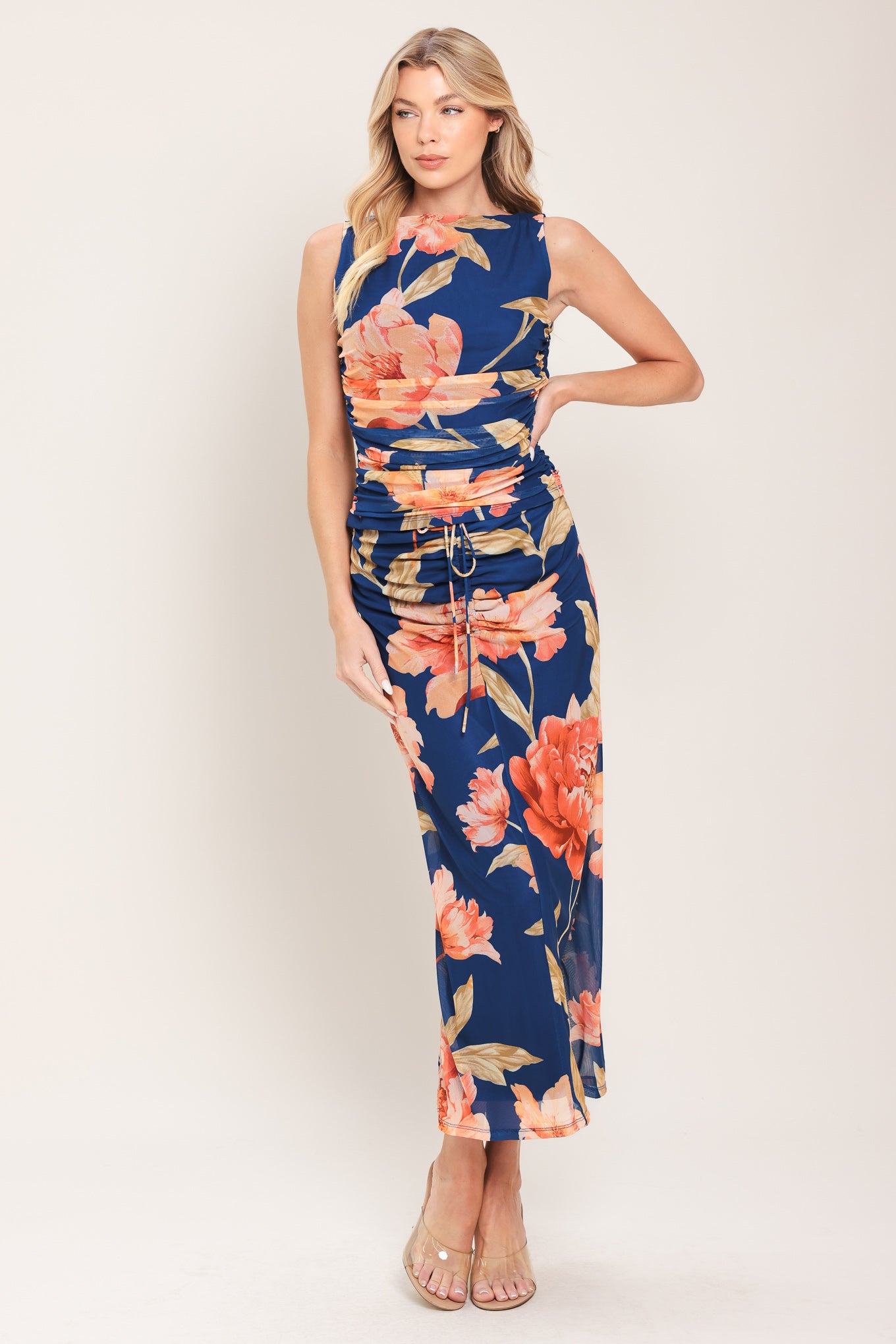 Woman wearing a navy blue with coral floral print power mesh tank top with side shirring | Flying Tomato