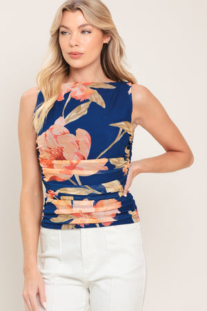 Woman wearing a navy blue with coral floral print power mesh tank top with side shirring | Flying Tomato