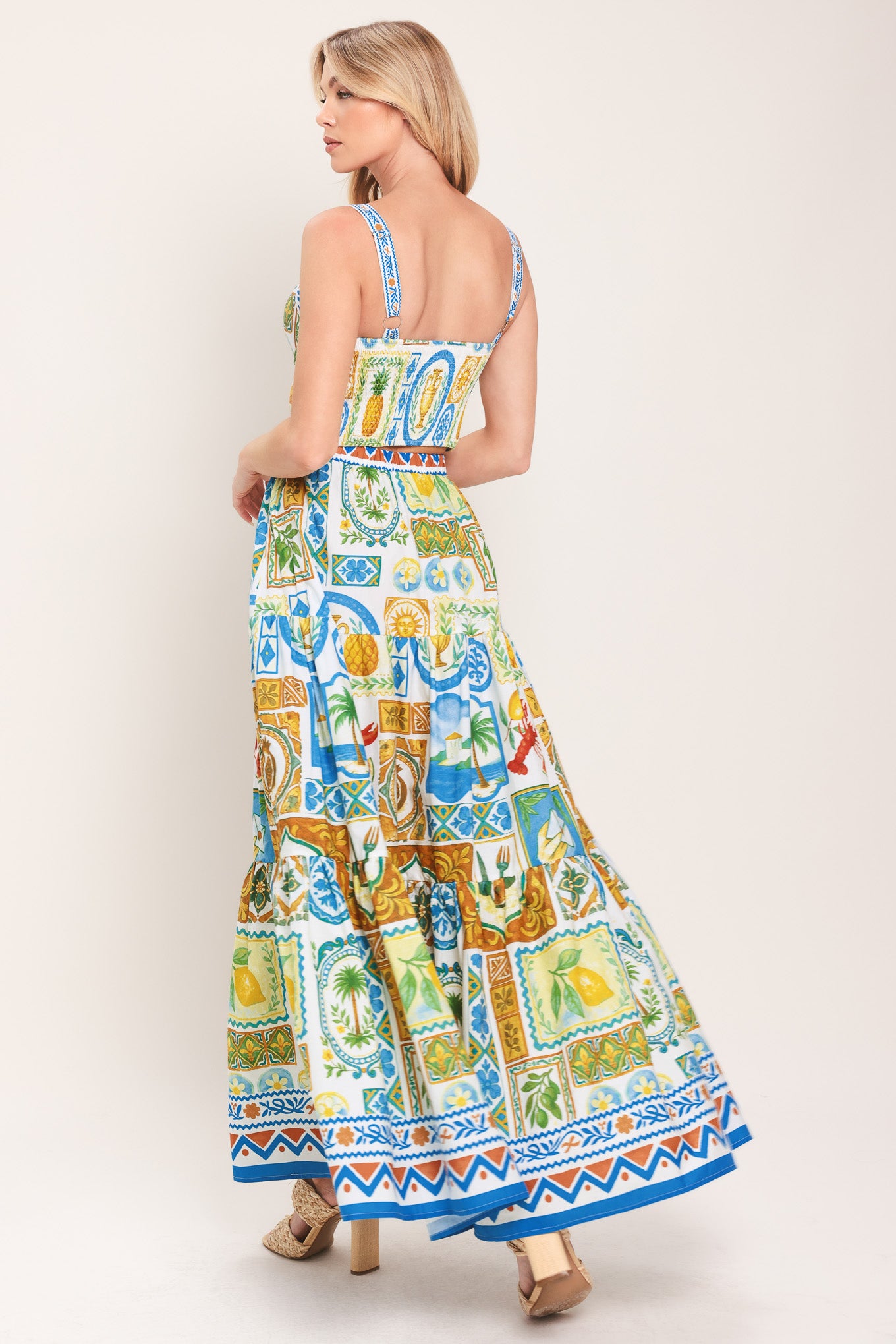 Woman wearing a printed bustier crop top with straps and smocked back bodice | Flying Tomato