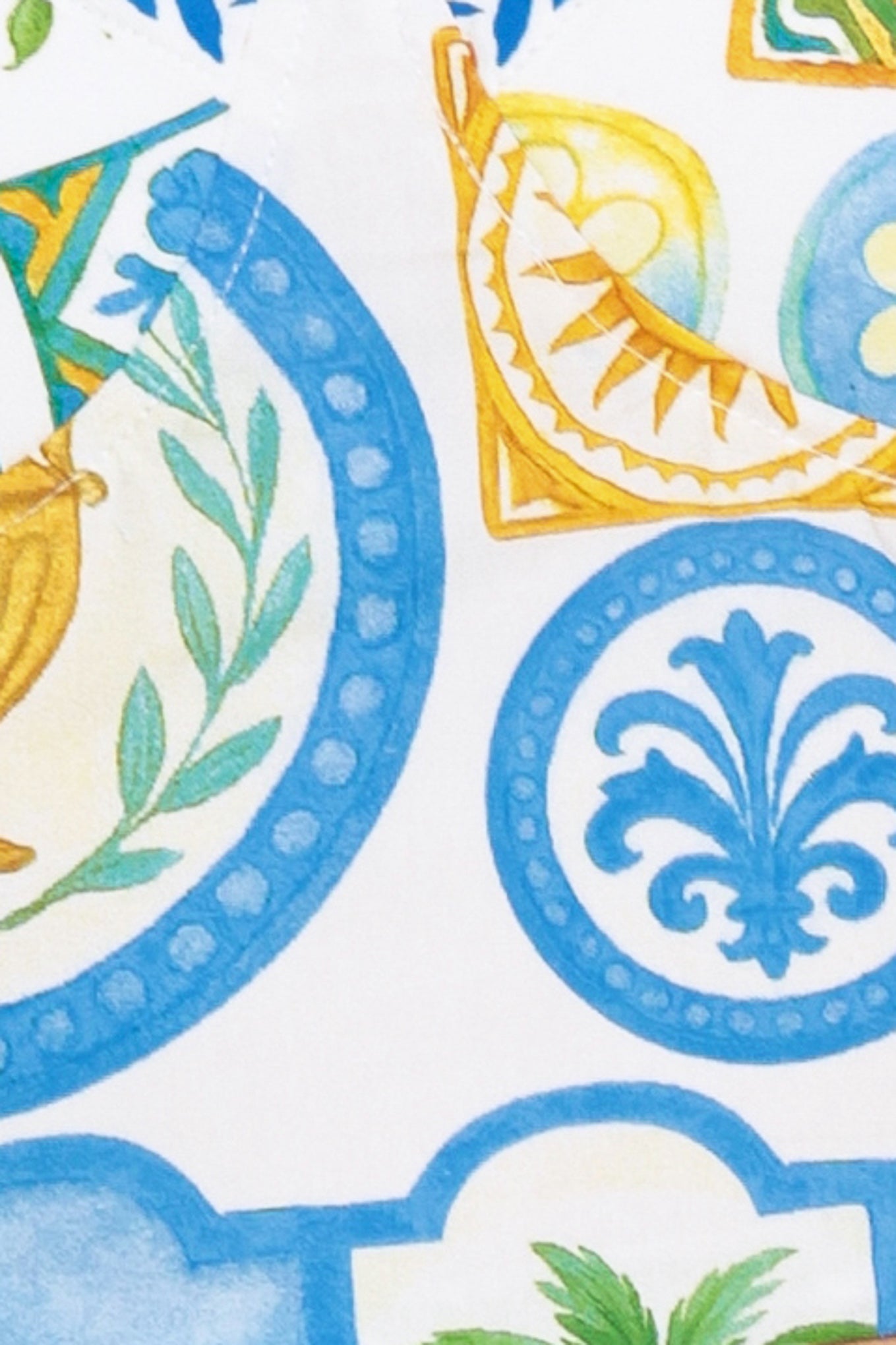 Close up of white fabric with blue and gold accents | Flying Tomato