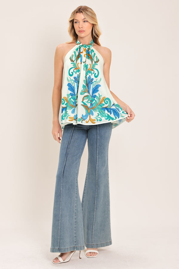Woman wearing an ivory with mint and blue floral halter top | Flying Tomato