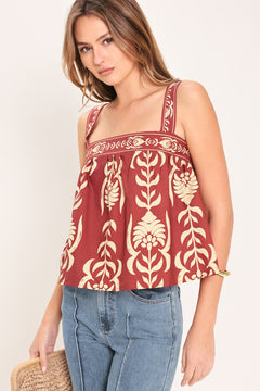Woman wearing a red and beige patterned top with straight neckline and straps | Flying Tomato