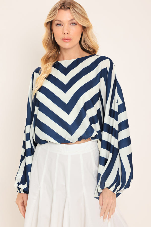 Woman wearing a navy and white chevron patterned top featuring wide neckline, dolman sleeve, elastic waist and back neck button closure | Flying Tomato