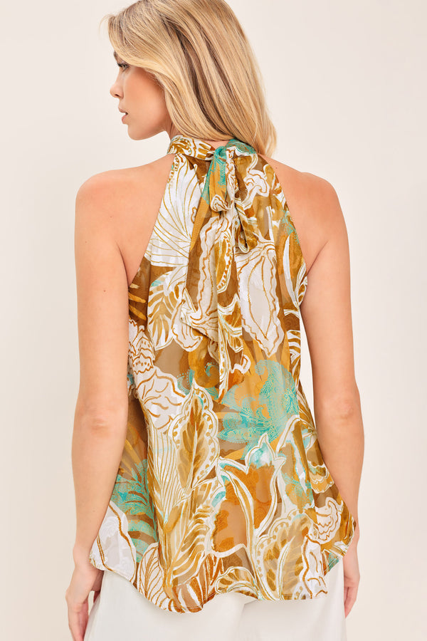 Woman wearing a sleeveless tropical floral jacquard printed top with halter neckline with back neck tie | Flying Tomato