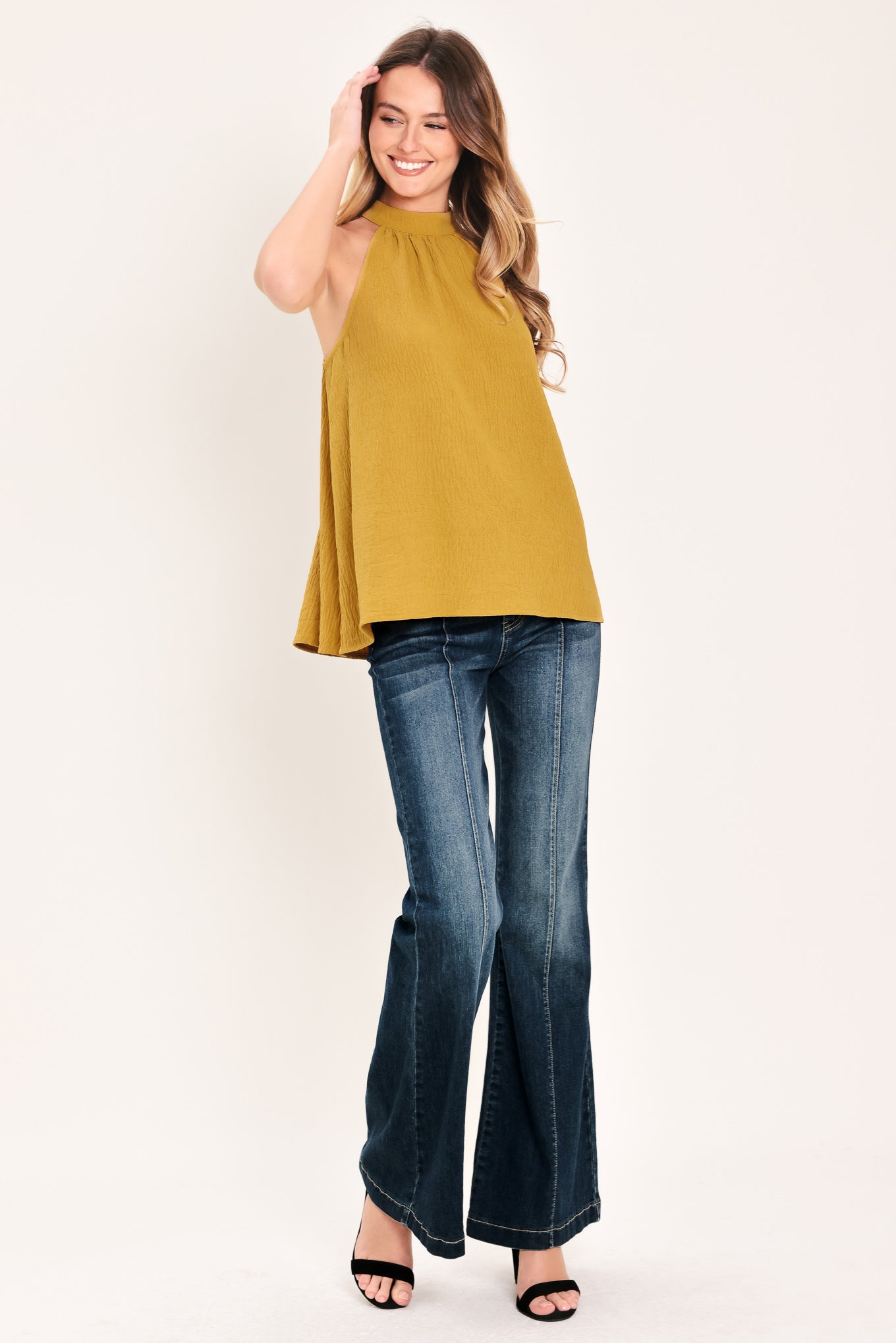 Woman wearing a mustard yellow sleeveless halter top | Flying Tomato