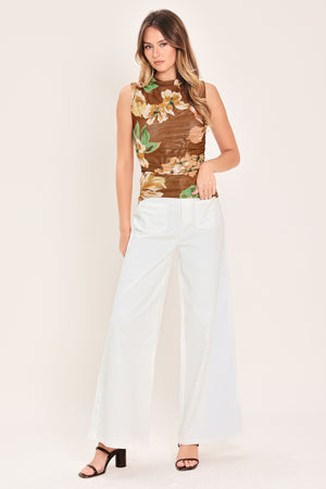 Woman wearing a brown floral sleeveless power mesh with funnel neck and side shirring | Flying Tomato
