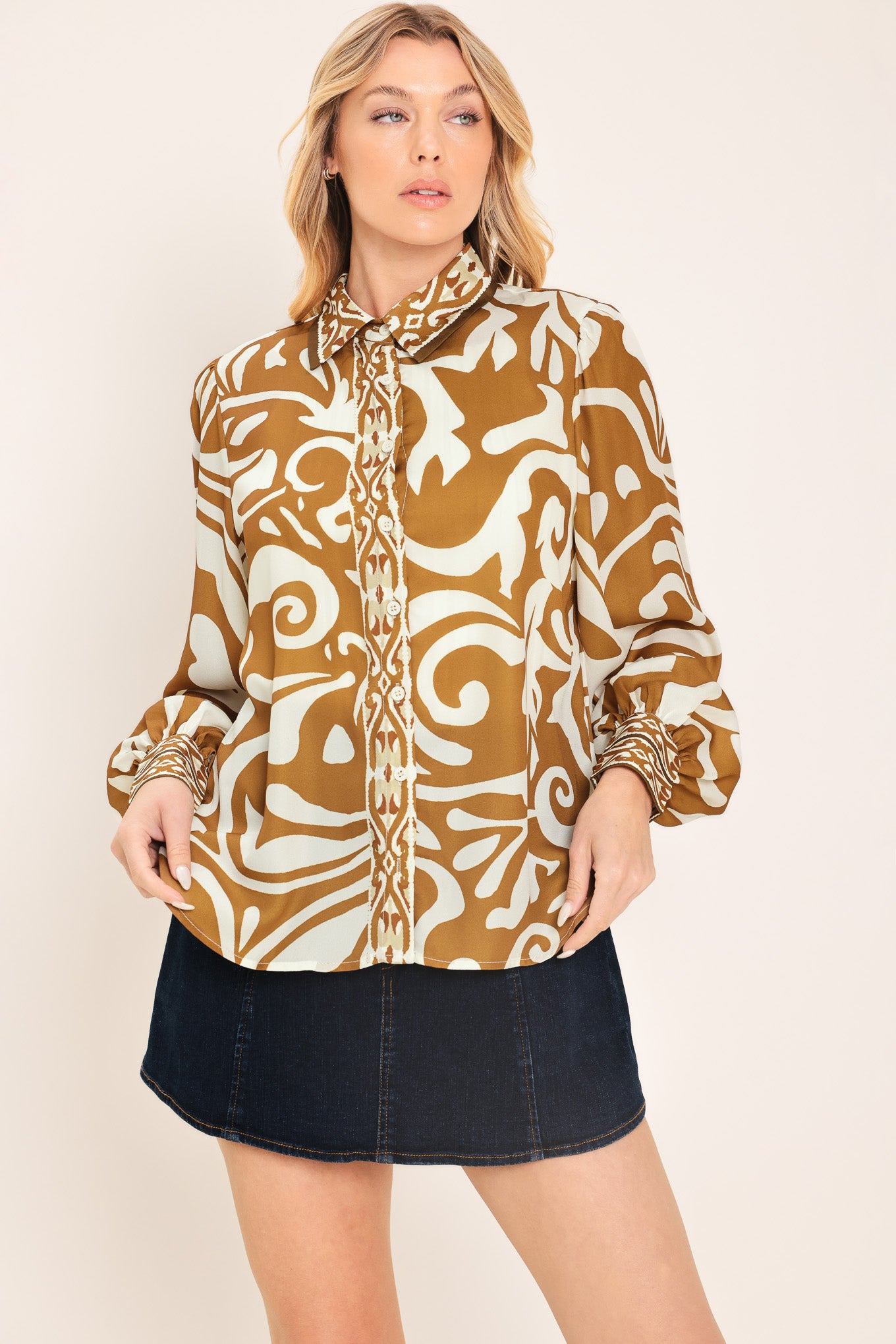 Woman wearing a brown and beige patterned collared blouse with buttons | Flying Tomato