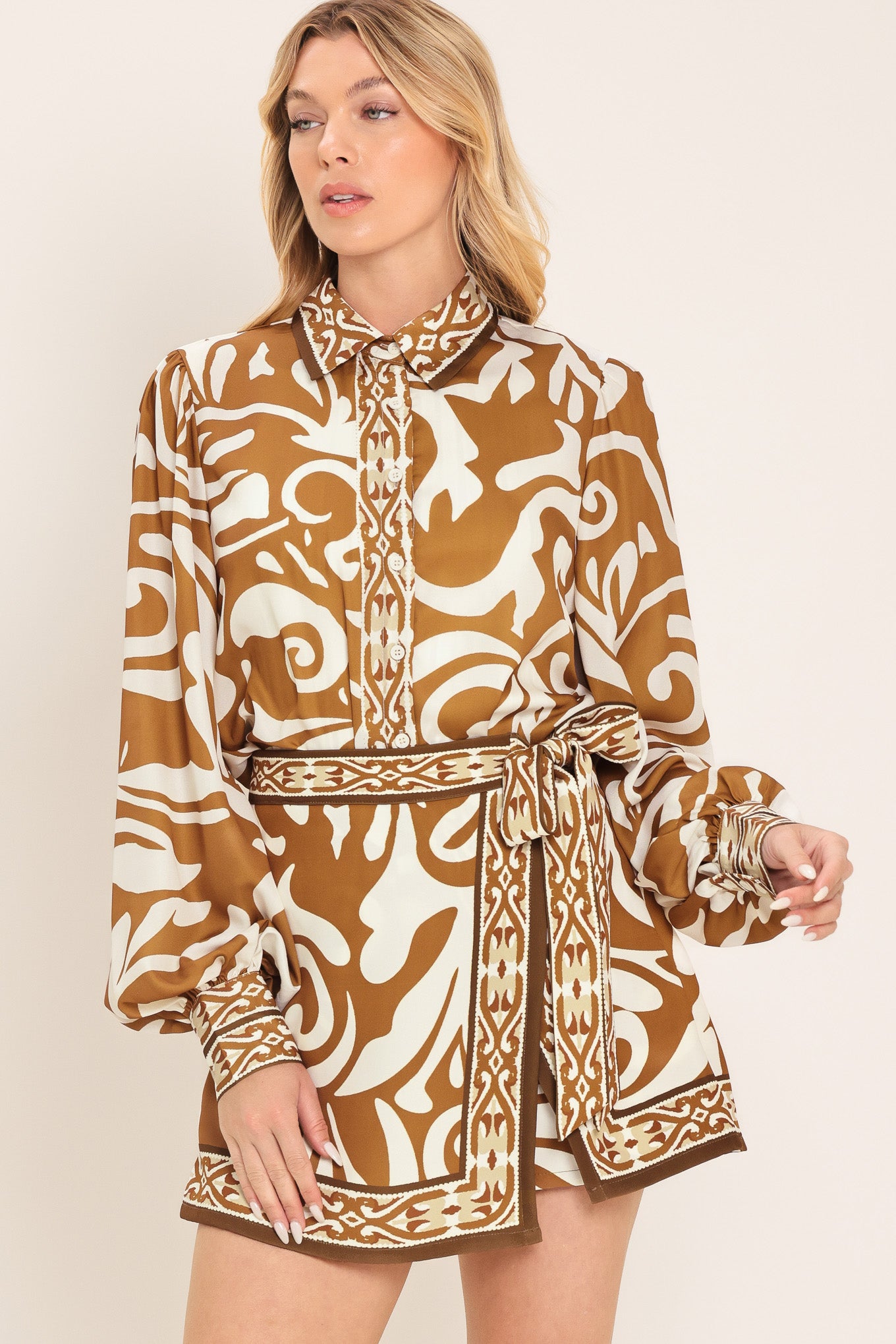 Woman wearing a brown and beige patterned collared blouse with buttons | Flying Tomato