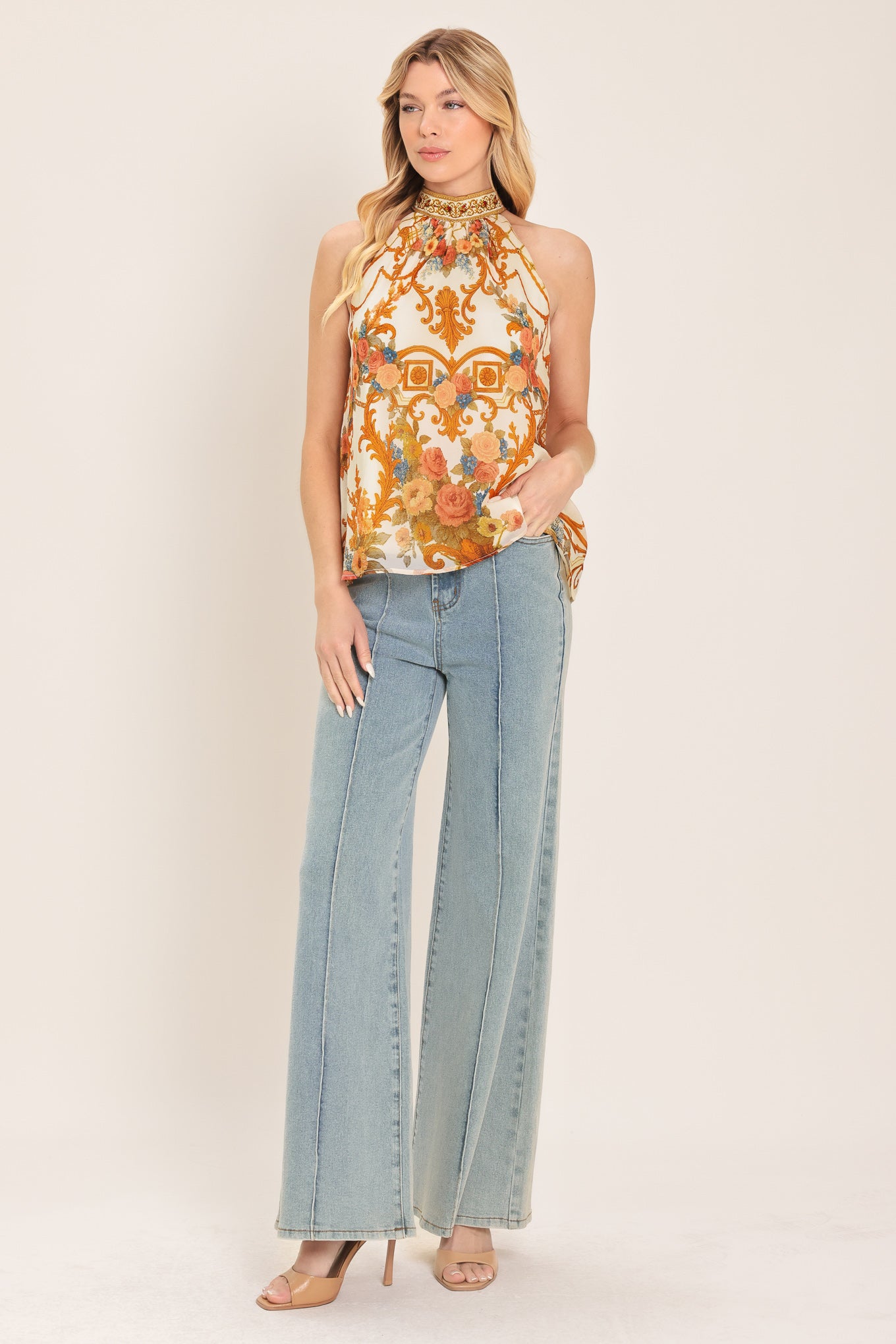 Woman wearing a sleeveless floral and geometric baroque patterned top | Flying Tomato