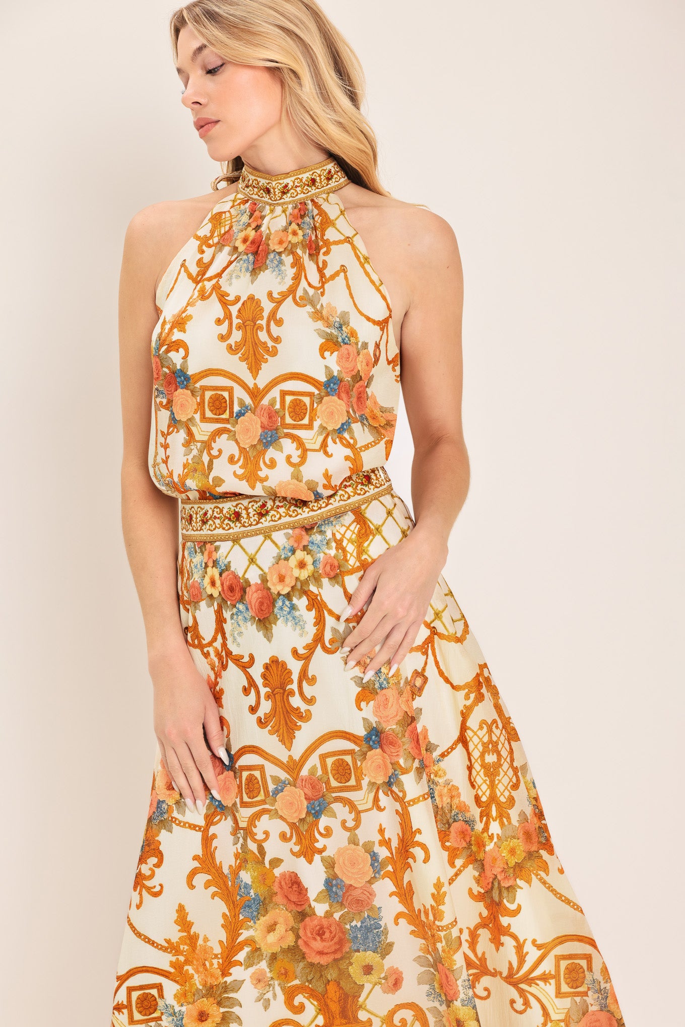 Woman wearing a sleeveless floral and geometric baroque patterned top | Flying Tomato