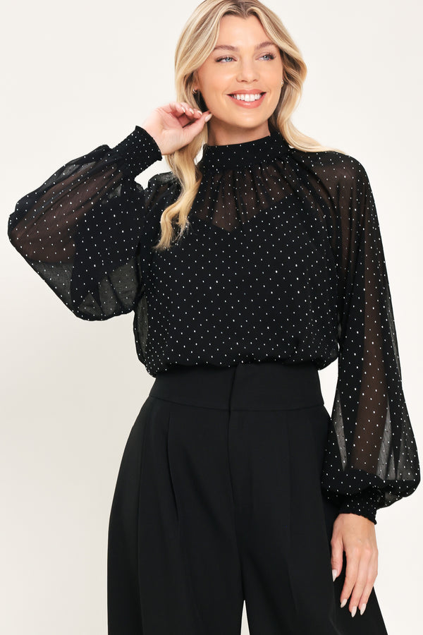 Woman wearing a long sleeve, mock neck, black top with small rhinestones | Flying Tomato