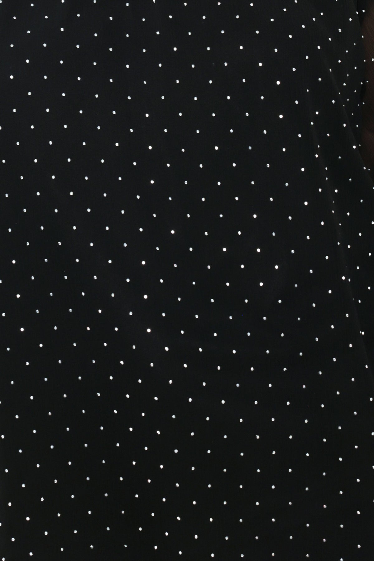Woman wearing a long sleeve, mock neck, black top with small rhinestones | Flying Tomato