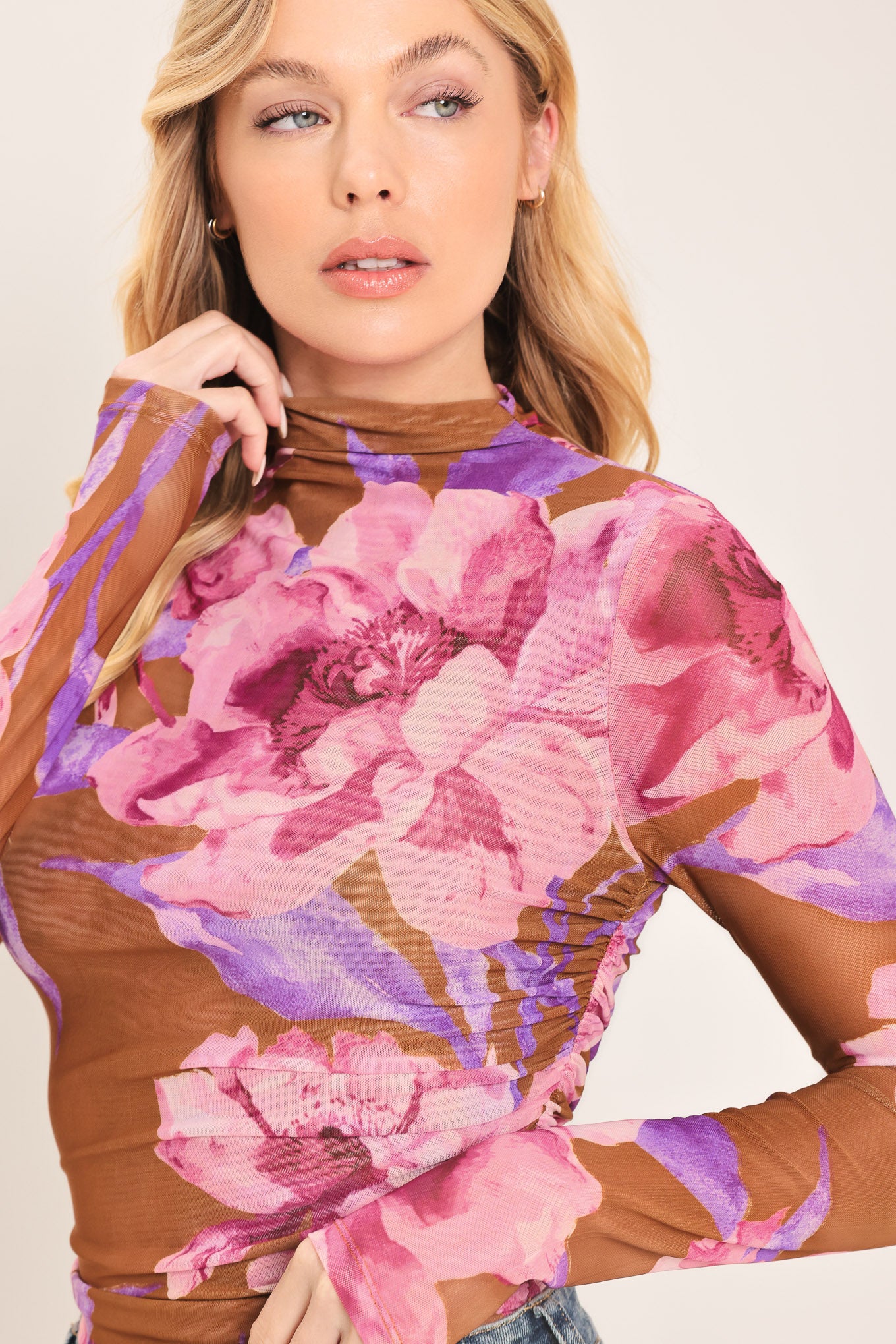 Woman wearing a floral long-sleeve power mesh brown top with pink and purple flowers | Flying Tomato