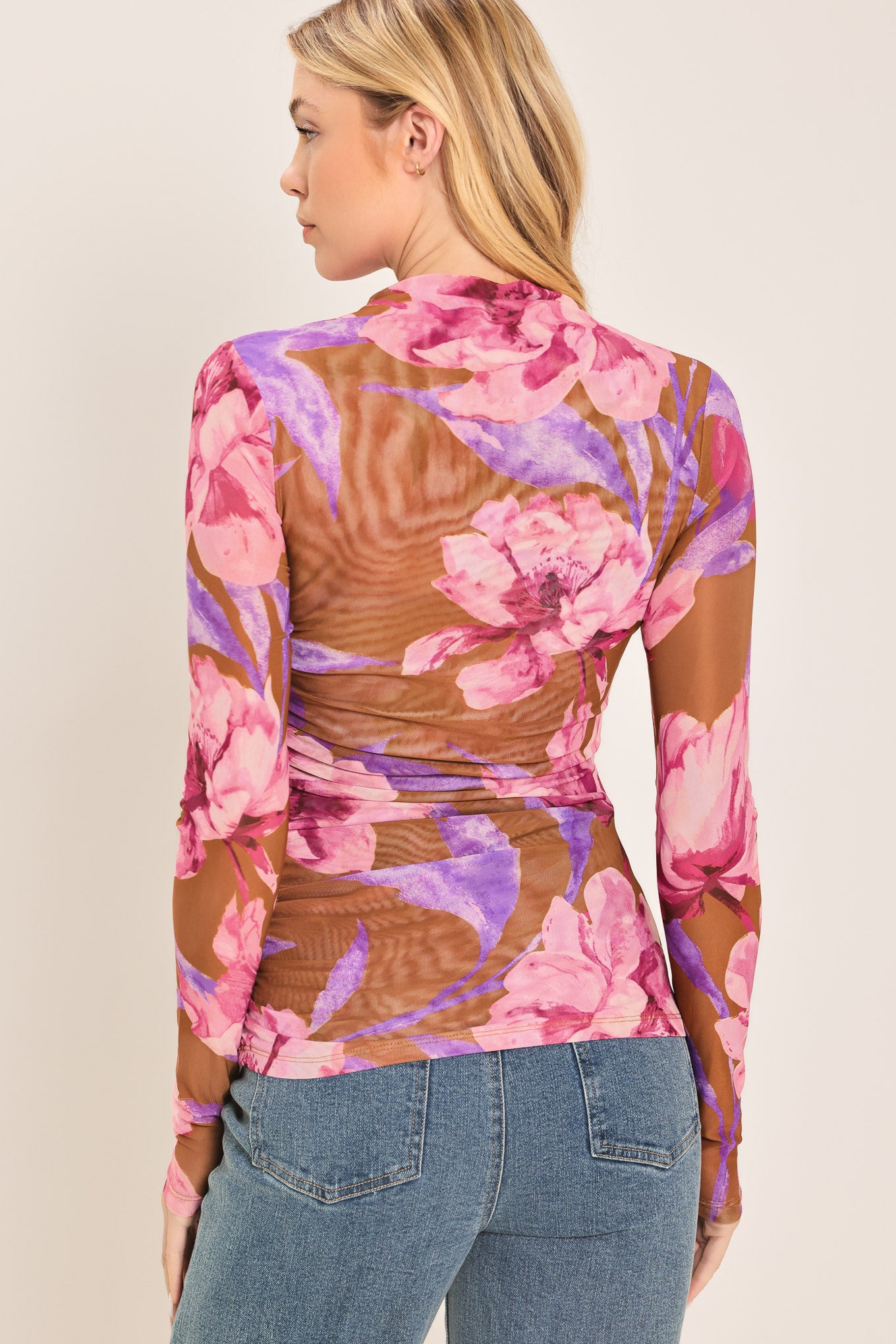 Woman wearing a floral long-sleeve power mesh brown top with pink and purple flowers | Flying Tomato