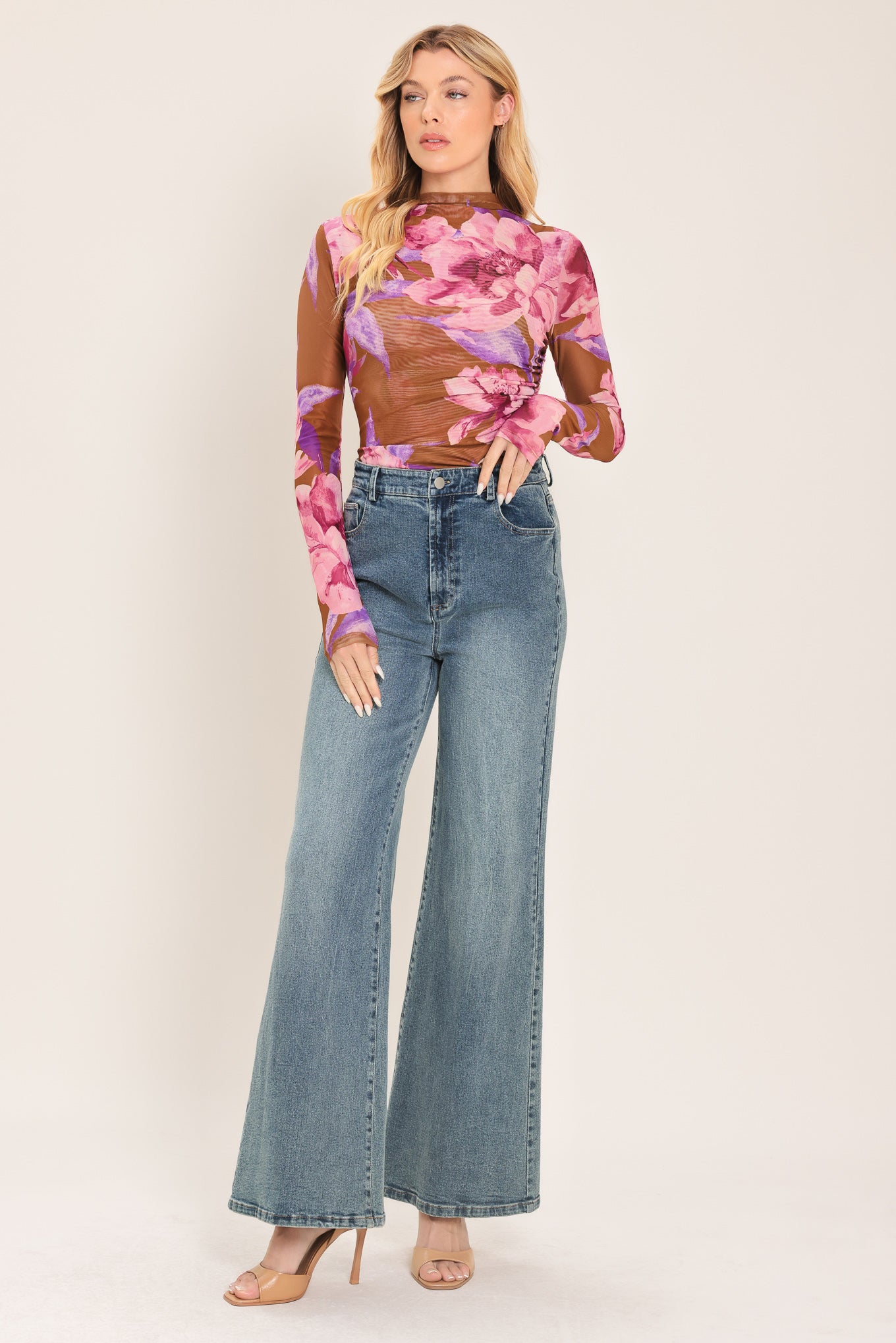 Woman wearing a floral long-sleeve power mesh brown top with pink and purple flowers | Flying Tomato