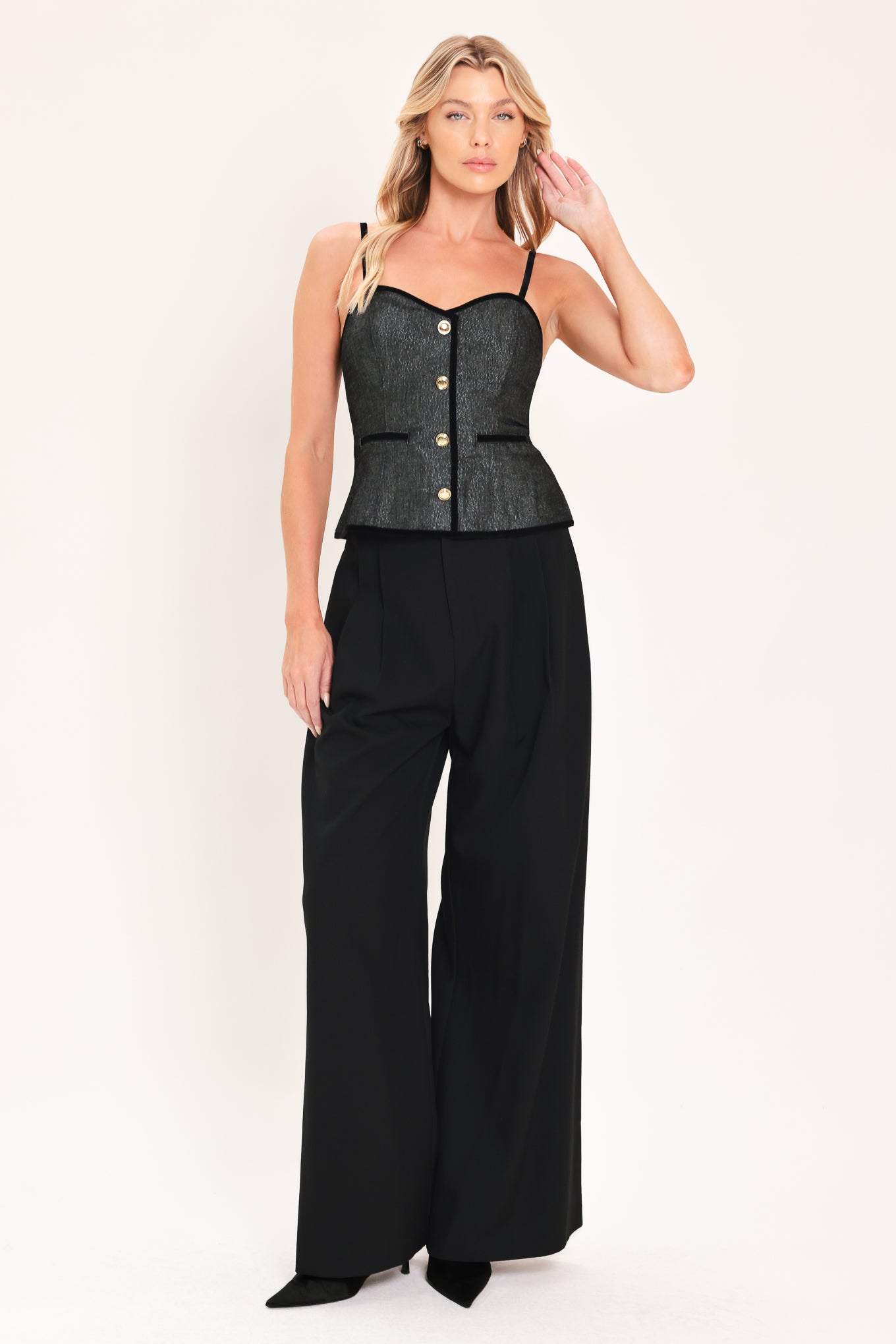 A woman modeling a structured black denim tweed camisole top with black trim and gold buttons | Flying Tomato