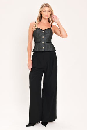 A woman modeling a structured black denim tweed camisole top with black trim and gold buttons | Flying Tomato