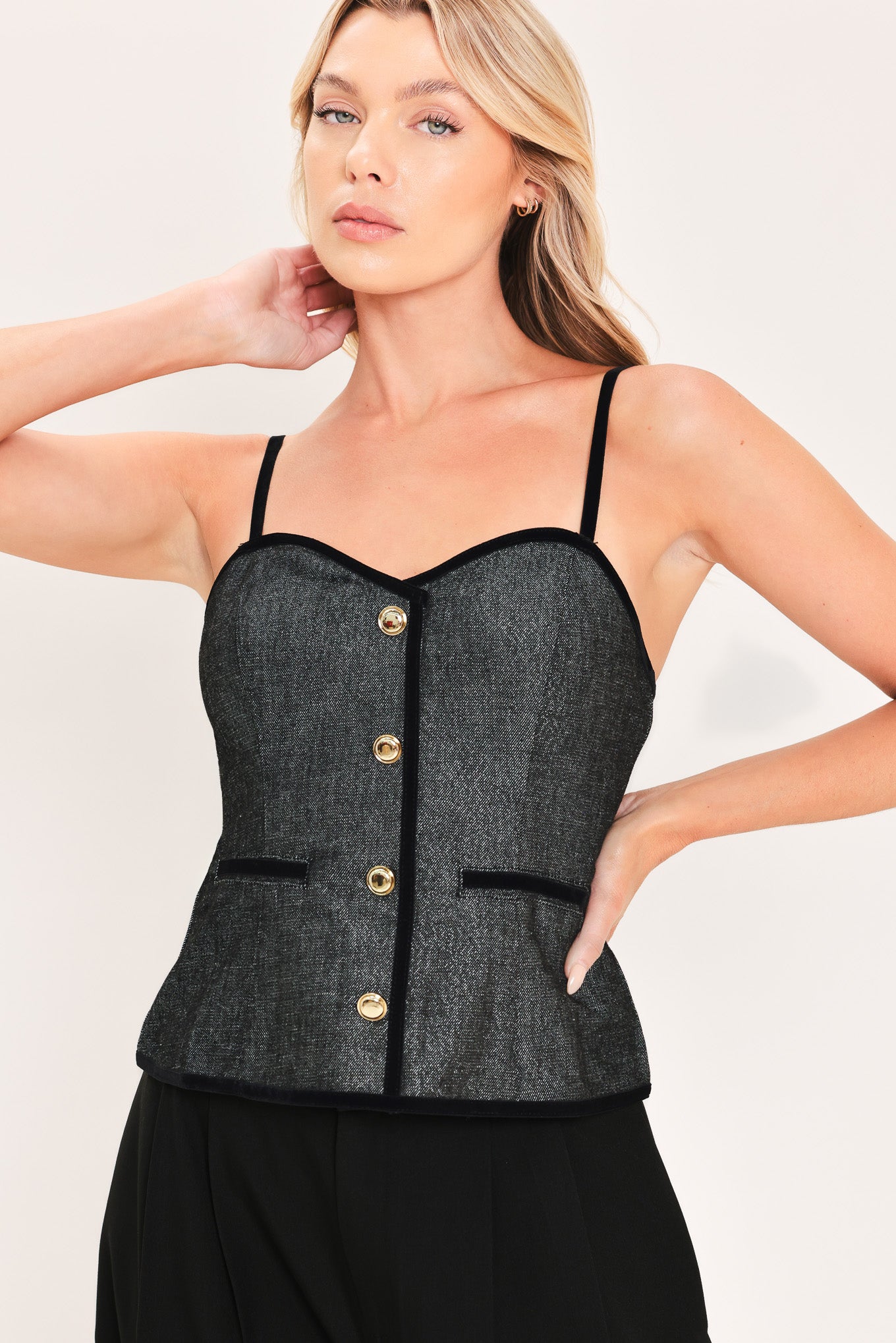 A woman modeling a structured black denim tweed camisole top with black trim and gold buttons | Flying Tomato