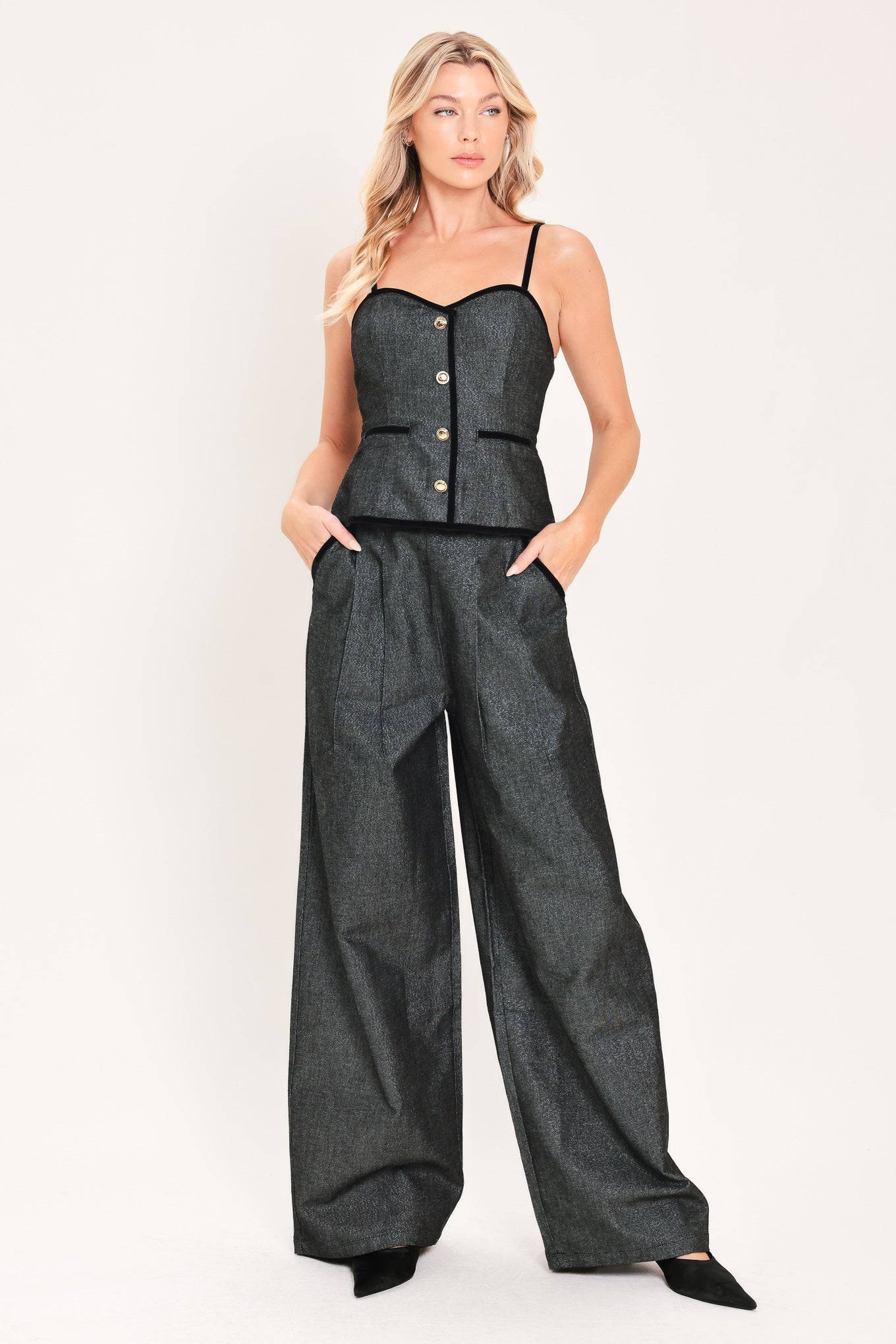 A woman modeling a structured black denim tweed camisole top with black trim and gold buttons | Flying Tomato