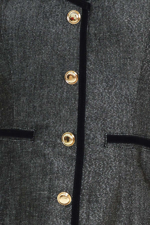 A woman modeling a structured black denim tweed camisole top with black trim and gold buttons | Flying Tomato
