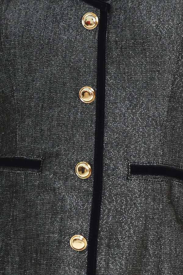 A woman modeling a structured black denim tweed camisole top with black trim and gold buttons | Flying Tomato