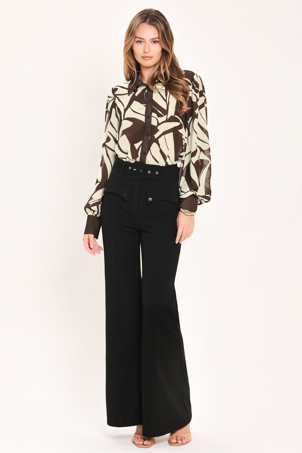 A woman wearing a long-sleeve button-up blouse with an abstract brown and cream pattern | Flying Tomato