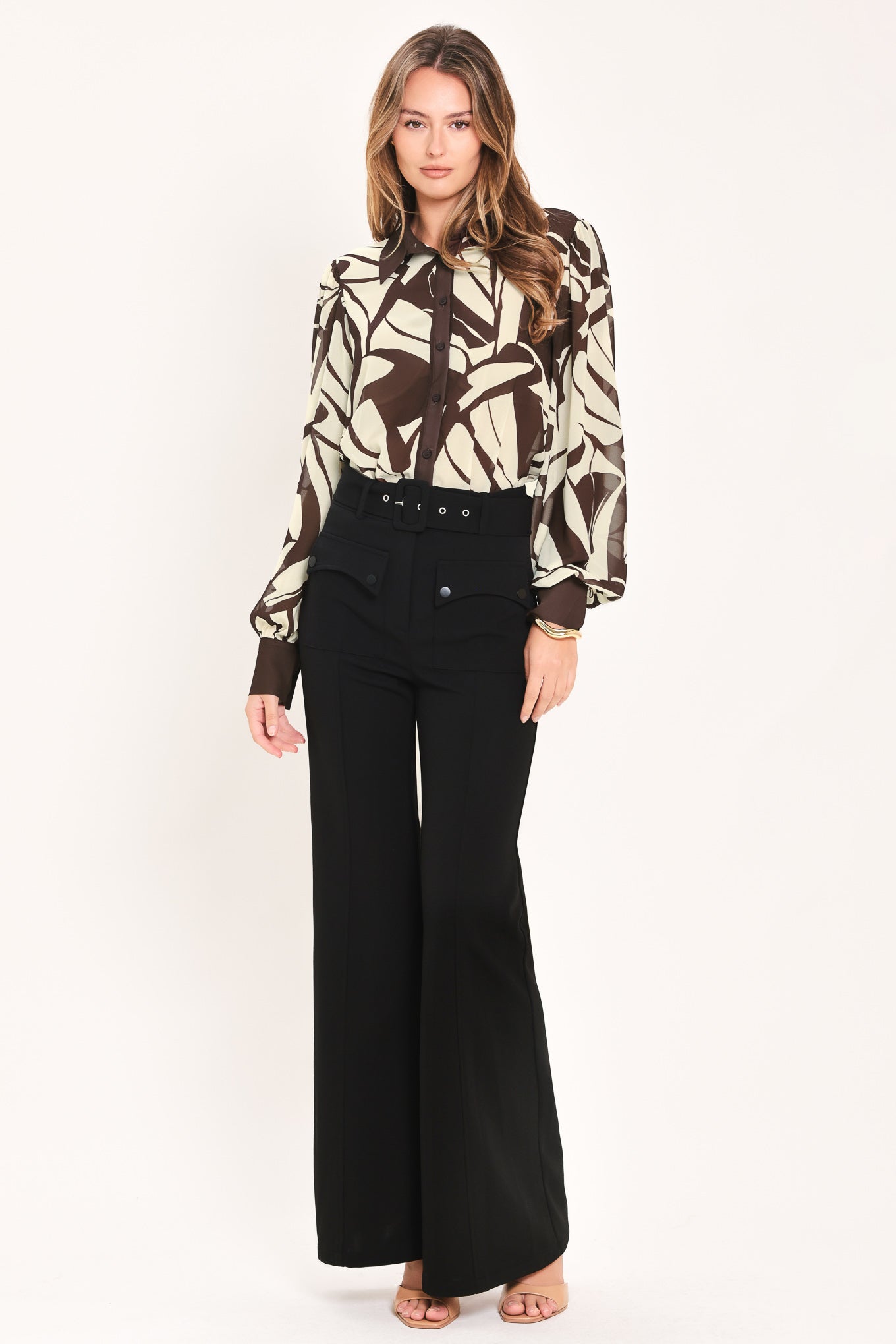 A woman wearing a long-sleeve button-up blouse with an abstract brown and cream pattern | Flying Tomato