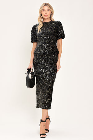 A woman modeling a black sequined short-sleeve top with puffed sleeves | Flying Tomato
