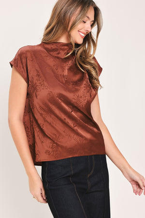 Woman wearing a cap sleeve burgundy satin jacquard top | Flying Tomato