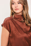 Woman wearing a cap sleeve burgundy satin jacquard top | Flying Tomato