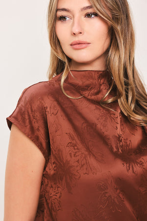 Woman wearing a cap sleeve burgundy satin jacquard top | Flying Tomato