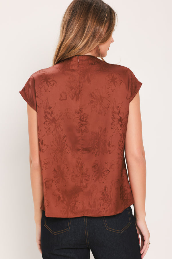 Woman wearing a cap sleeve burgundy satin jacquard top | Flying Tomato