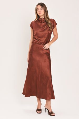Woman wearing a cap sleeve burgundy satin jacquard top | Flying Tomato