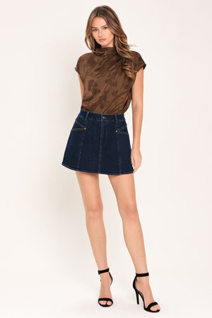 Woman wearing a brown jacquard top featuring funnel neckline, short sleeve and back zipper closure | Flying Tomato