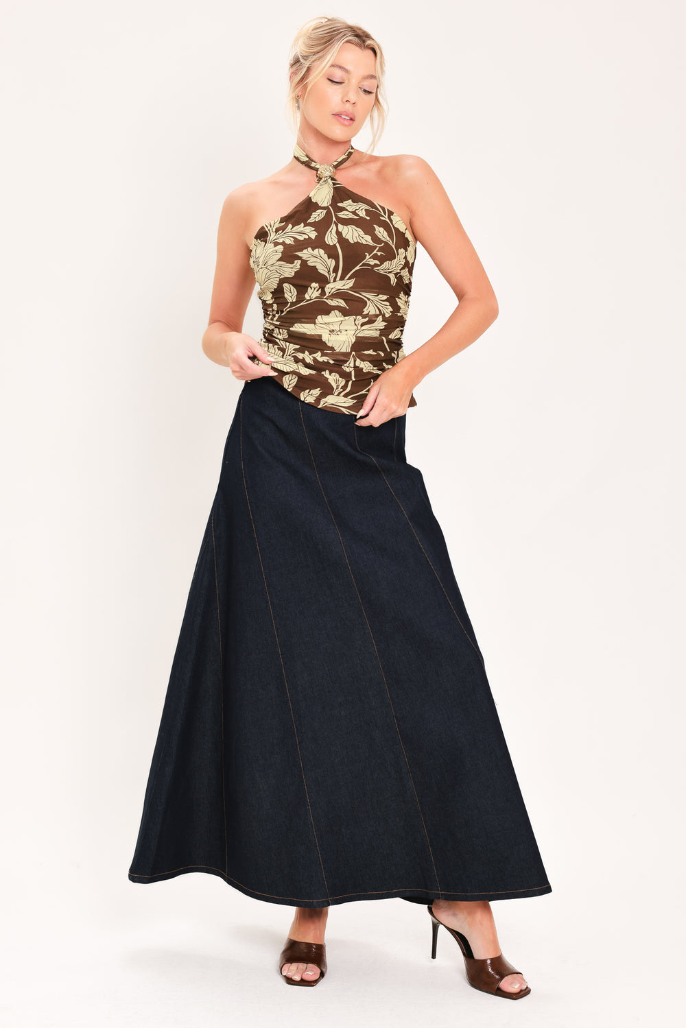 A woman wearing a brown halter-neck top with a beige floral print | Flying Tomato