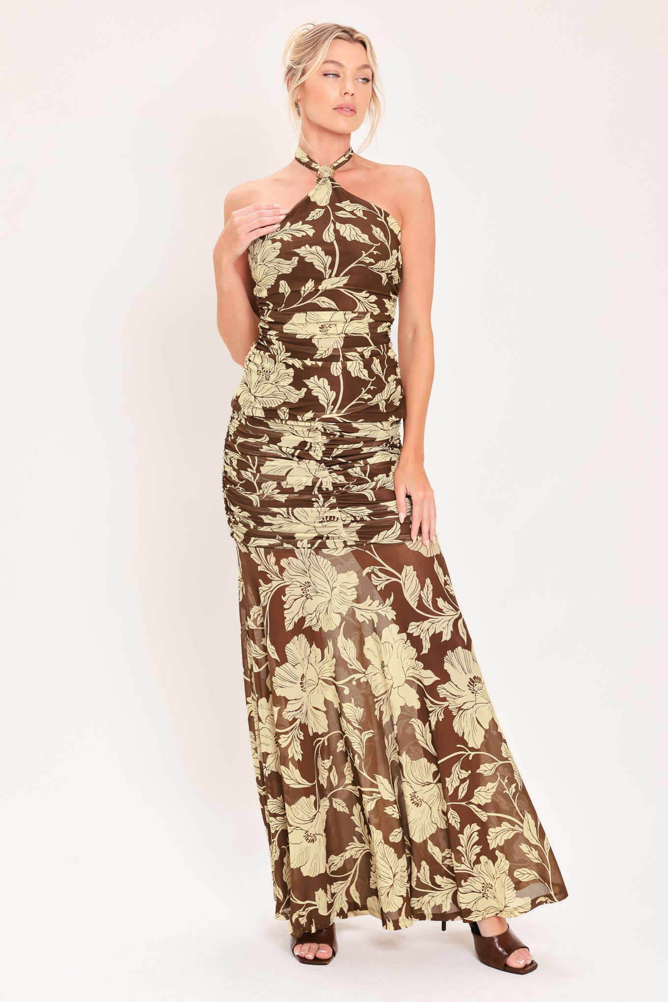 A woman wearing a brown halter-neck top with a beige floral print | Flying Tomato