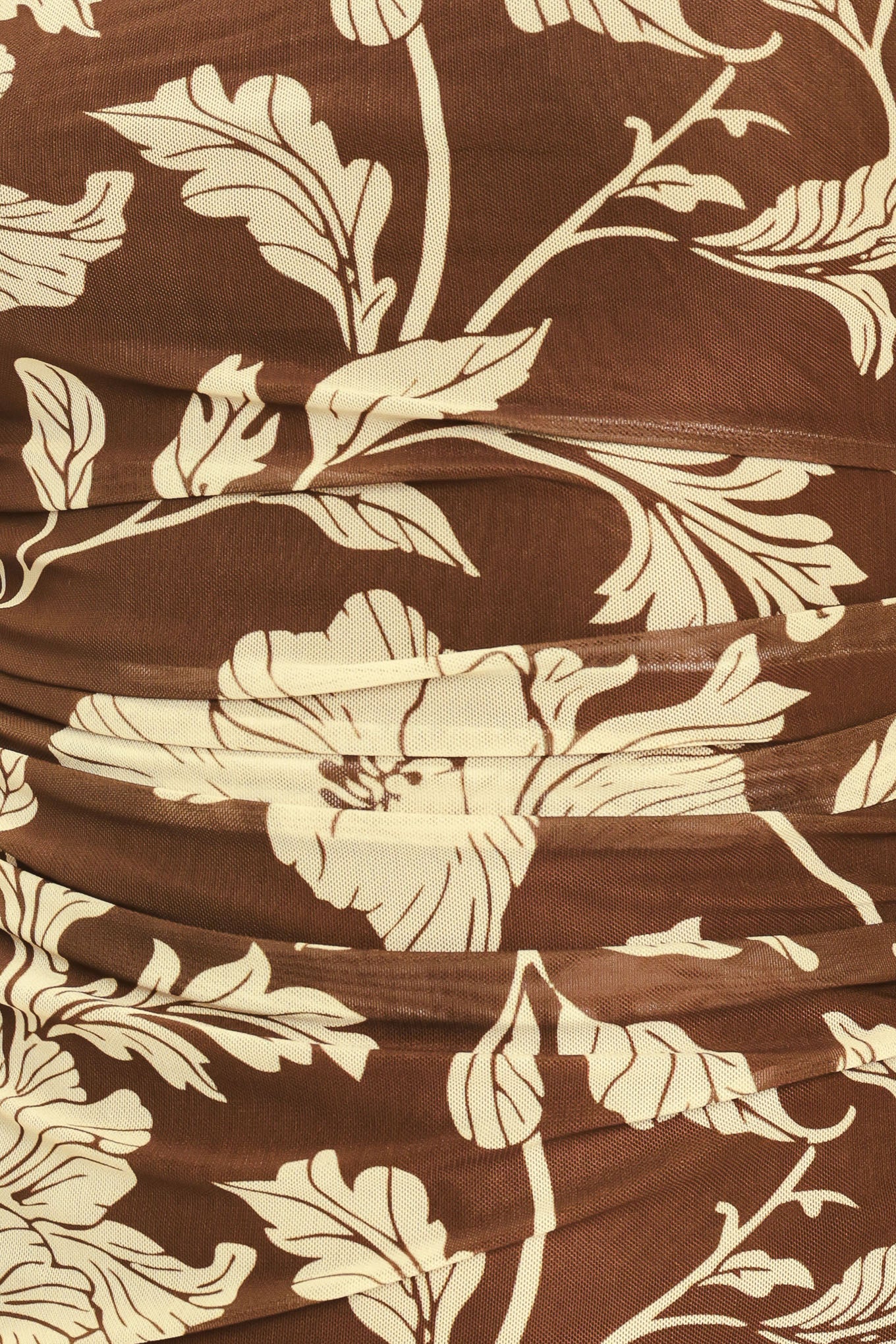 A woman wearing a brown halter-neck top with a beige floral print | Flying Tomato