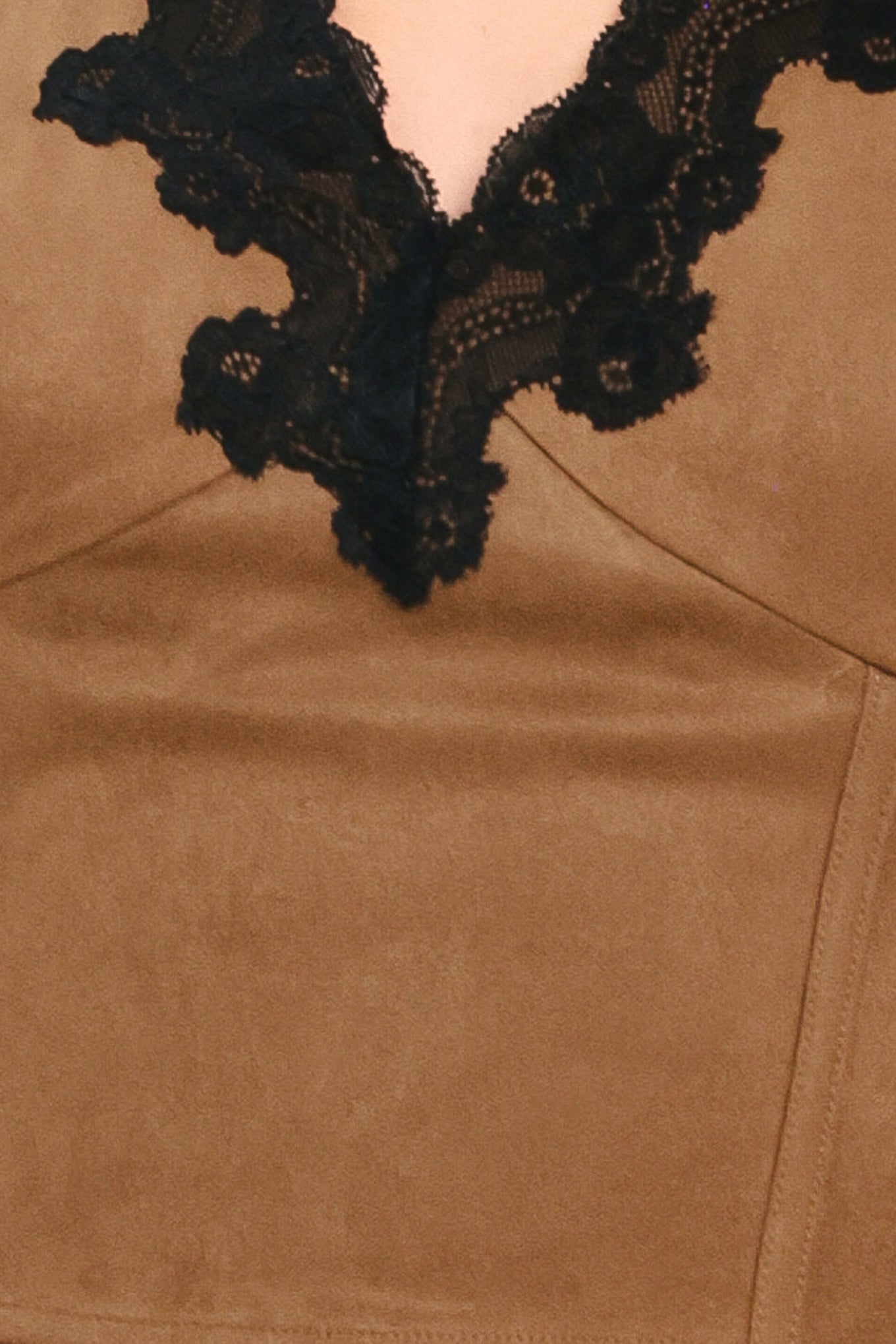 A woman wearing a faux suede brown sleeveless crop top with a black lace V-neck trim | Flying Tomato