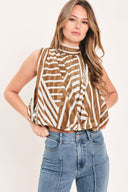 Woman wearing a sleeveless mocha and white geometric striped top with a high neck and flow silhouette | Flying Tomato