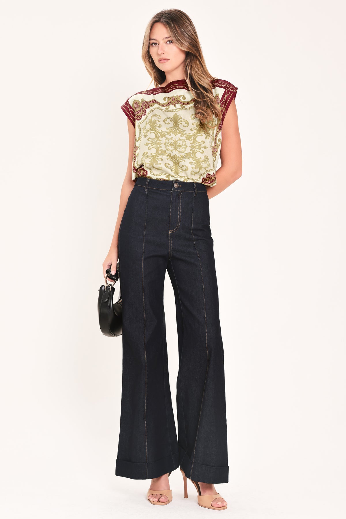 A woman wearing a sleeveless top with a cream base and ornate burgundy and olive-gold baroque-style border and damask pattern | Flying Tomato