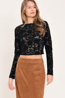 A woman wearing a black long-sleeve lace crop top  | Flying Tomato
