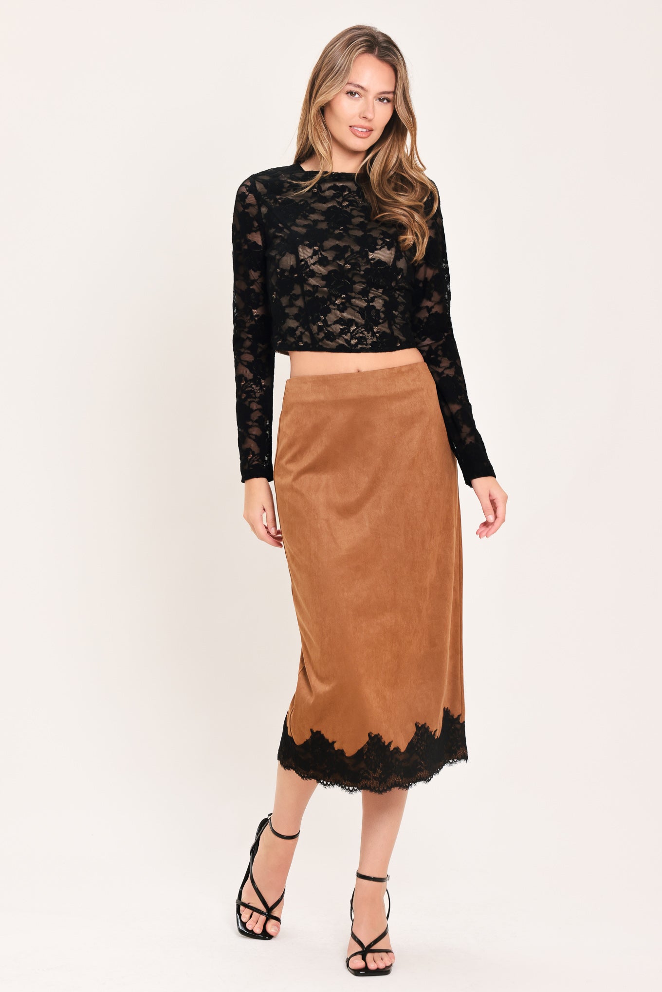 A woman wearing a black long-sleeve lace crop top  | Flying Tomato