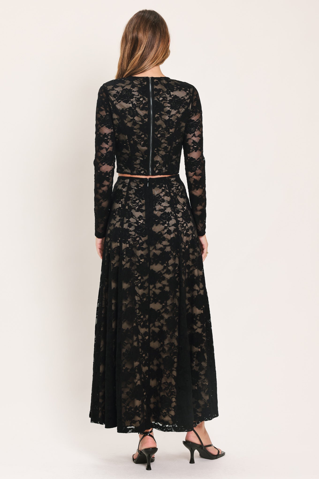 A woman wearing a black long-sleeve lace crop top  | Flying Tomato