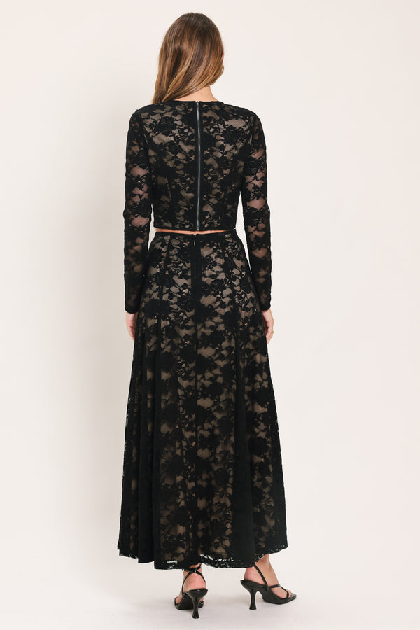 A woman wearing a black long-sleeve lace crop top  | Flying Tomato