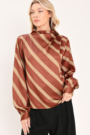 A woman wearing a brown and beige diagonally striped satin blouse with long balloon sleeves | Flying Tomato