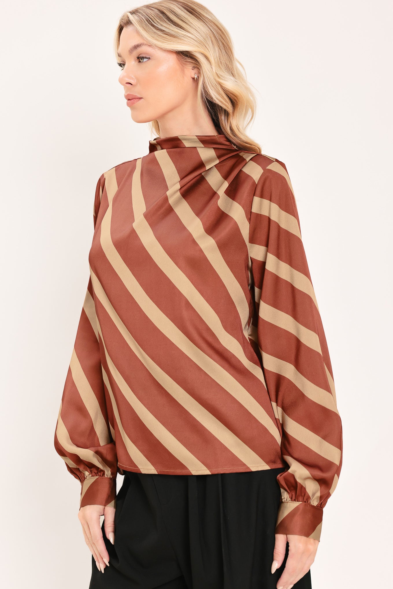 A woman wearing a brown and beige diagonally striped satin blouse with long balloon sleeves | Flying Tomato