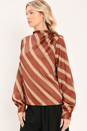 A woman wearing a brown and beige diagonally striped satin blouse with long balloon sleeves | Flying Tomato