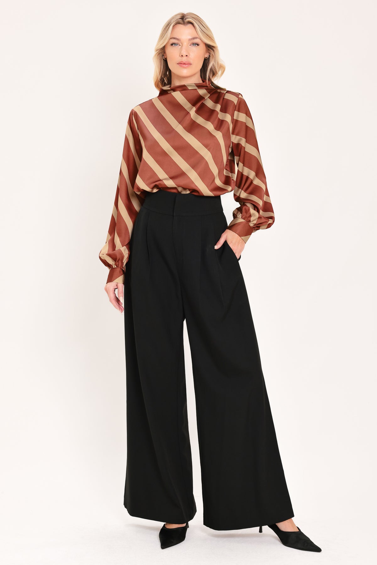A woman wearing a brown and beige diagonally striped satin blouse with long balloon sleeves | Flying Tomato