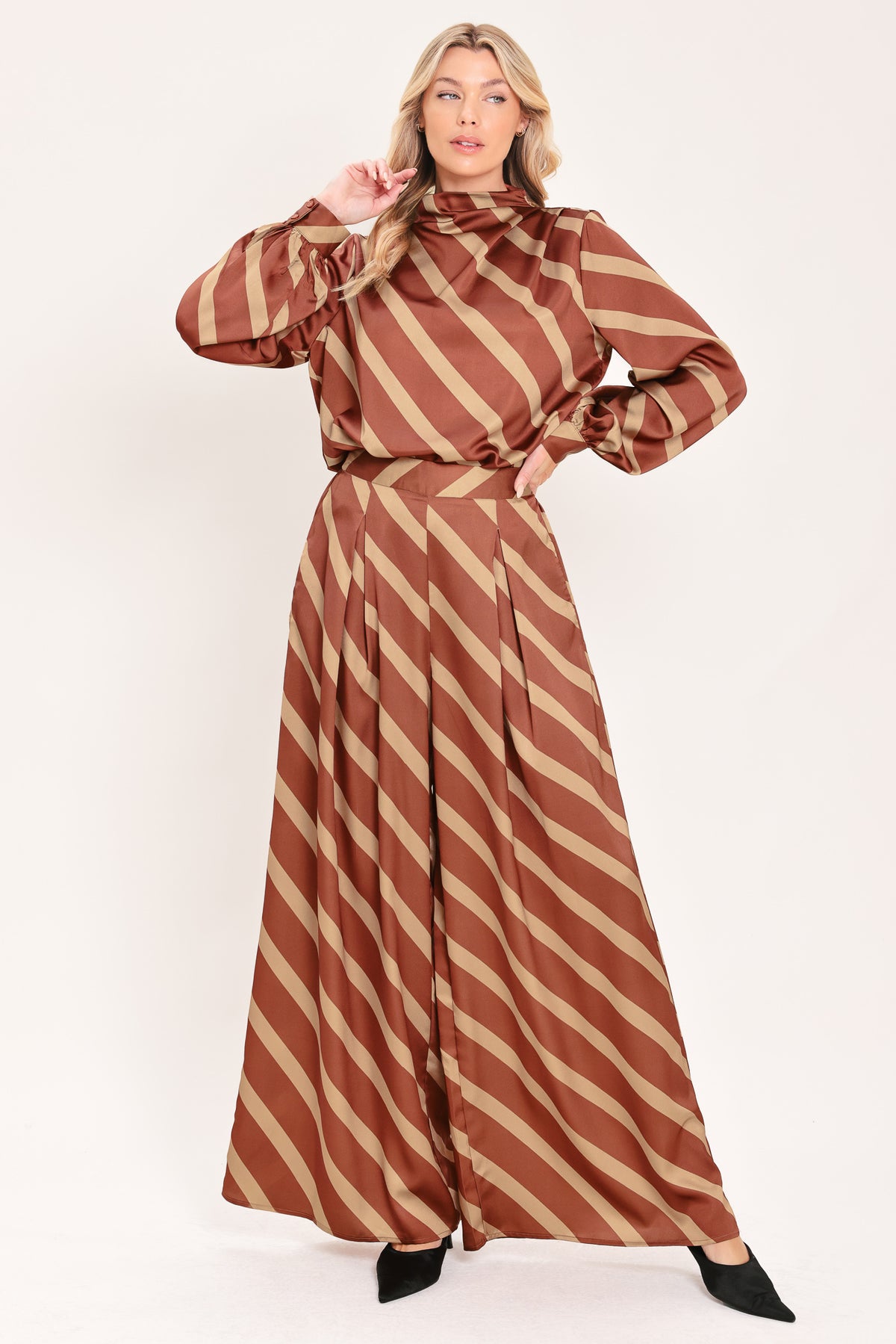A woman wearing a brown and beige diagonally striped satin blouse with long balloon sleeves | Flying Tomato