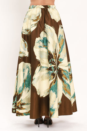 A woman modeling a sleeveless top and  matching maxi skirt with a brown and cream floral print and teal accents | Flying Tomato